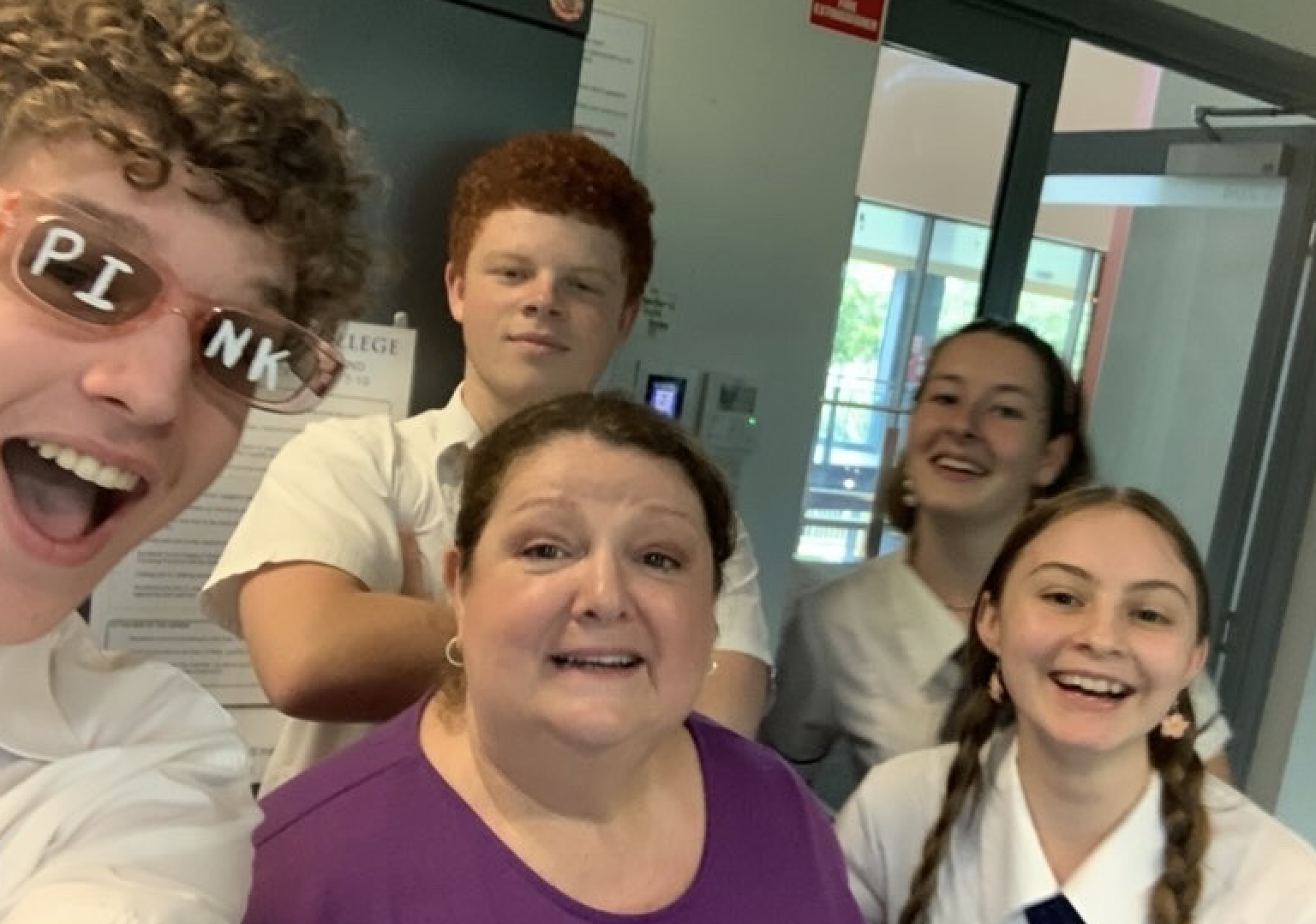 Tate, Teacher and friends posing on last week of Grade 12