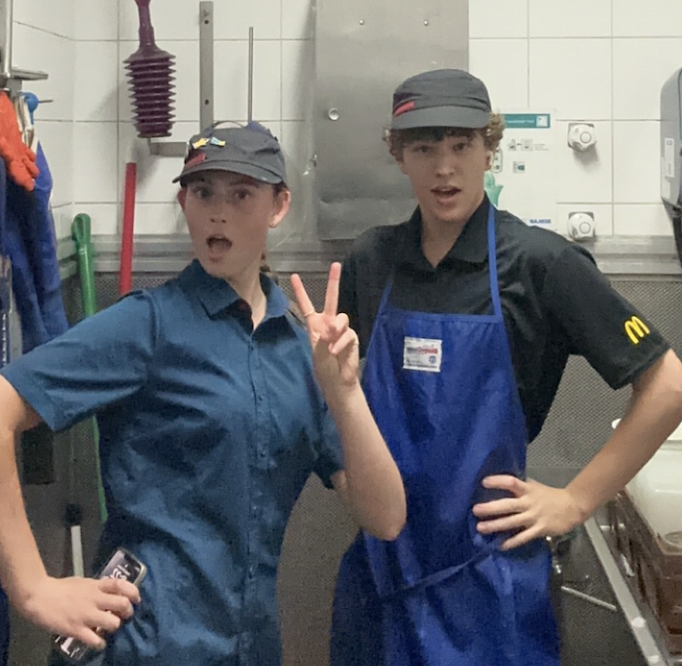 Tate and Sarah posing in wash up gear at work
